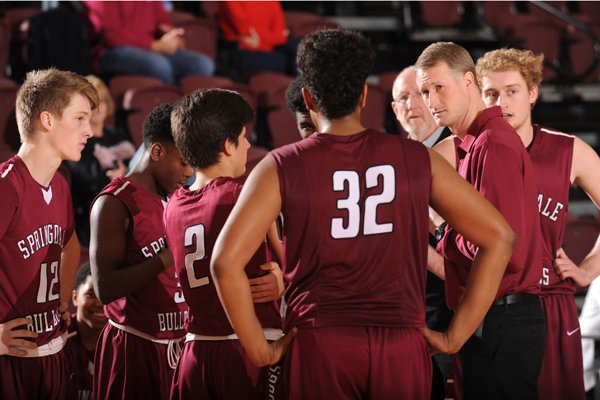 Springdale coach Jeremy Price (right) speaks to his team against Tulsa (Okla.) Holland Hall Tuesday. Dec. 29, 2015, during the second half at Siloam Springs High School.