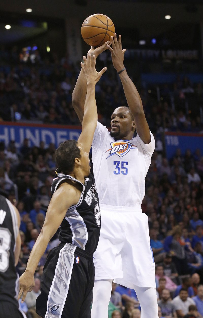 Oklahoma City Thunder forward Kevin Durant, right, shoots Saturday over San Antonio Spurs guard Andre Miller, left, in the second quarter of an NBA basketball game in Oklahoma City. 