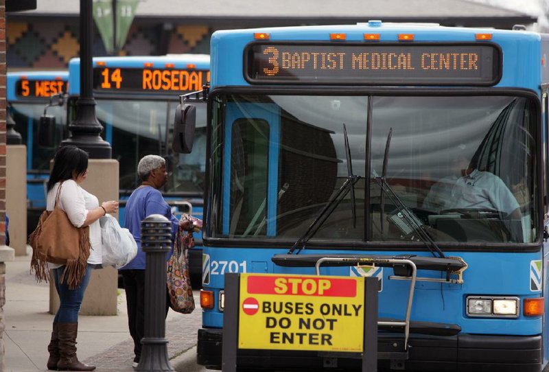 Arkansans board a bus at the River Cities Travel Center in downtown Little Rock on Wednesday. Rock Region Metro officials are planning to improve its services despite voters turning down a sales-tax increase earlier this month to provide transit funding.
