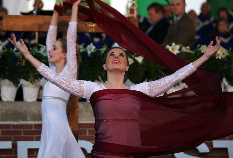 Erin Sanders (front) and Kathleen Marleneanu of New Creation Dance Company perform during the Community Easter Sunrise Service at First Security Amphitheater in downtown Little Rock on Sunday.Arkansas Democrat-Gazette/MITCHELL PE MASILUN