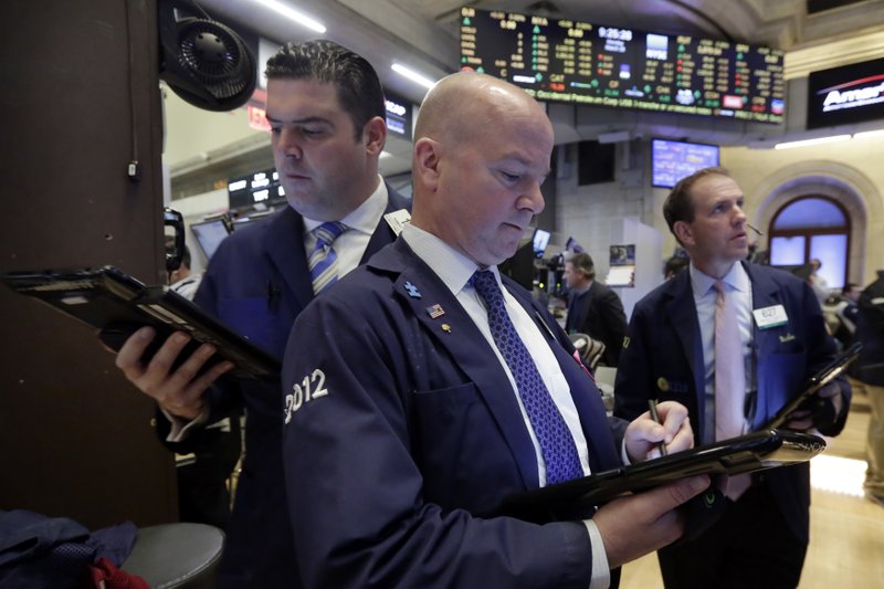 Trader Patrick Casey, center, works on the floor of the New York Stock Exchange, Monday, March 28, 2016.  