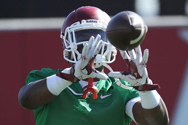 Arkansas running back Rawleigh Williams III catches a pass Tuesday, March 29, 2016, during practice at the university's practice field on campus in Fayetteville.