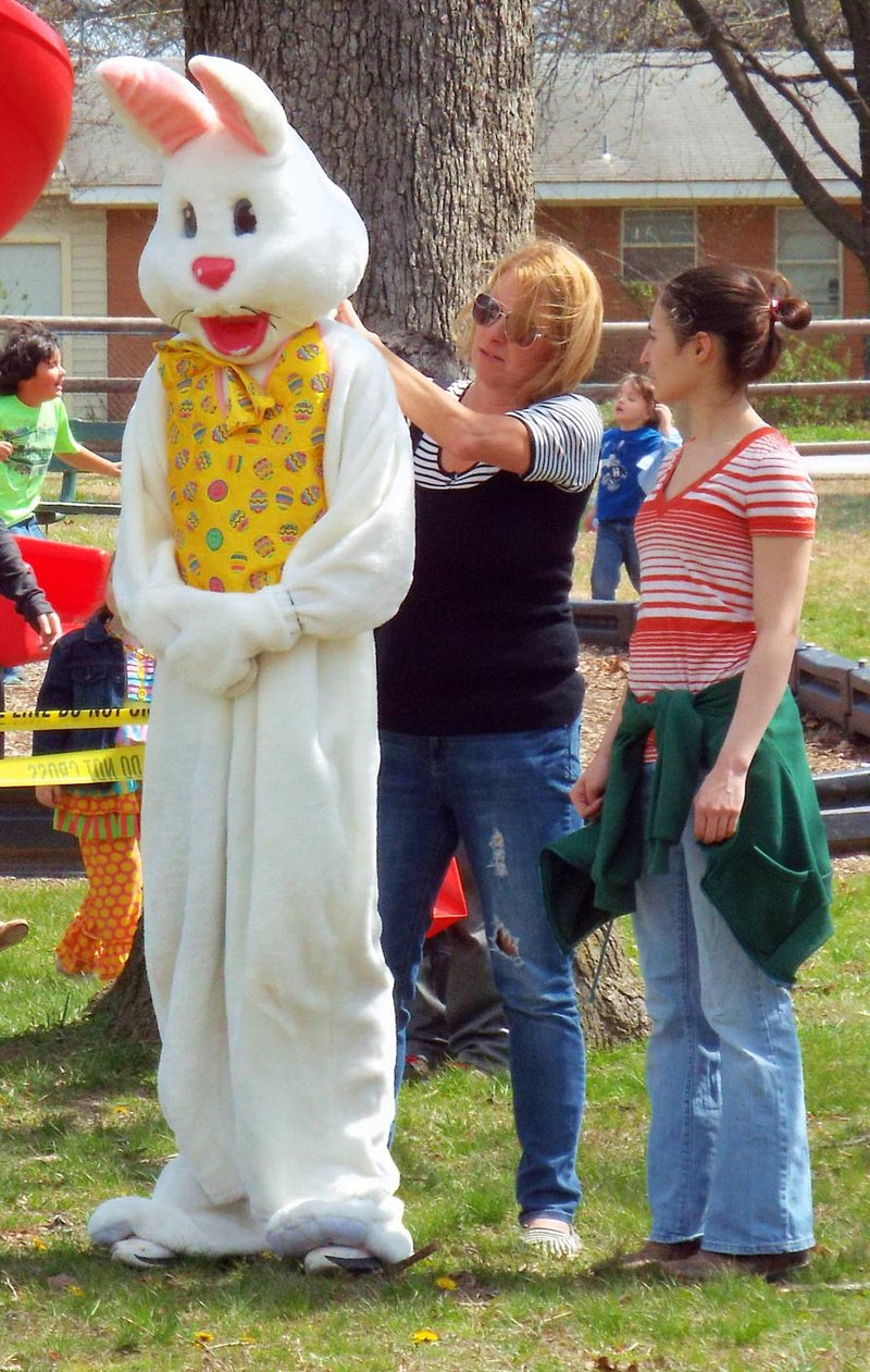 Photo by Randy Moll The Easter Bunny needed just a little help from Mom to get the costume in place at the Chamber of Commerce Easter egg hunt on Saturday in Gentry City Park.