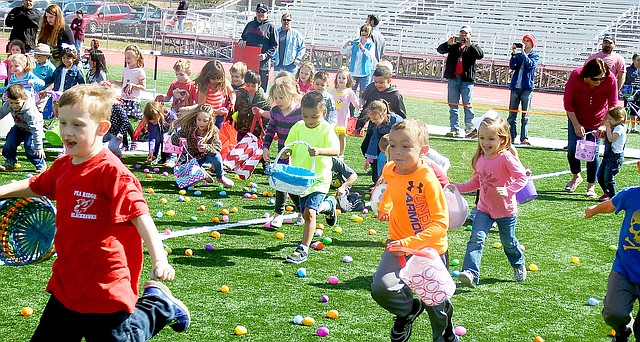 And they&#8217;re off &#8212; childran ran onto the field to gather eggs, then gathered with family members to collect the candy from the eggs after the egg hunt Saturday.