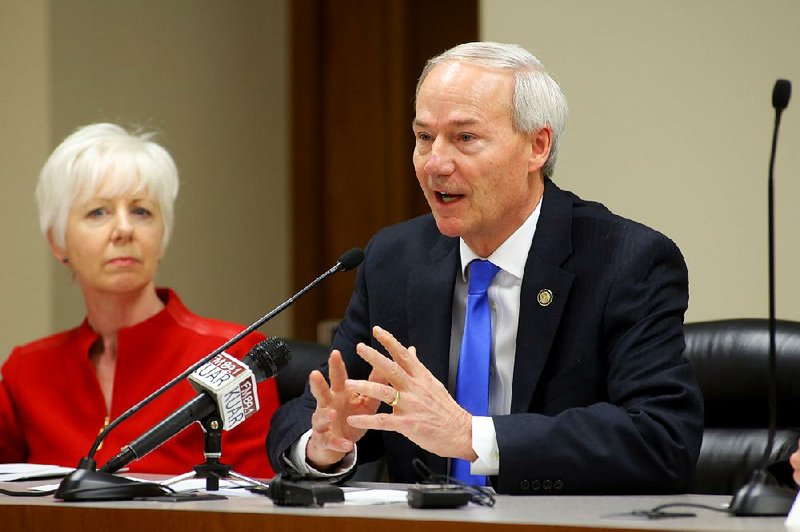 Gov. Asa Hutchinson, with Department of Human Services Director Cindy Gillespie, addresses his Medicaid advisory council Wednesday at the Capitol on his agenda for the Medicaid special session.
