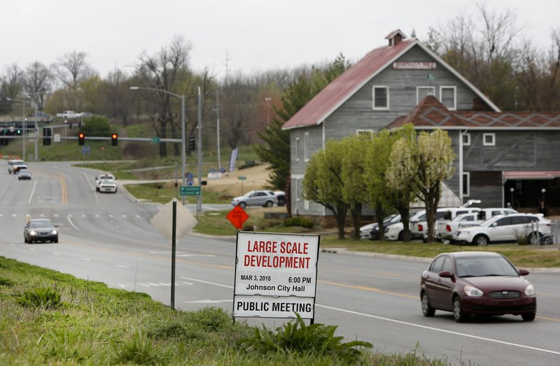 Real estate signs and new development are visible near the Inn at the Mill in Johnson on Wednesday along Johnson Mill Boulevard east of Interstate 49. 