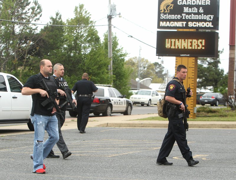 Officers from the Hot Springs Police and Garland County Sheriff's Department work the scene of an incident at Gardner Magnet School Wednesday, March 30, 2016. Apparently some pest control company employees walked by the school with some pellet rifles causing a teacher to hit the panic button prompting a response to the school. (The Sentinel-Record/Richard Rasmussen)