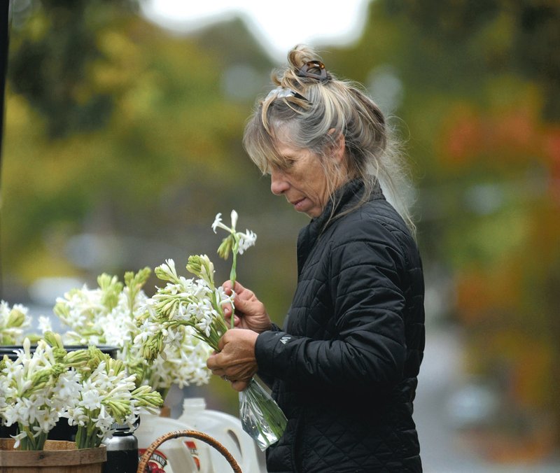 Terri Bitting of Plentygood Farm in Springdale prepares bouquets for sale at the 2015 Fayetteville Farmers’ Market.