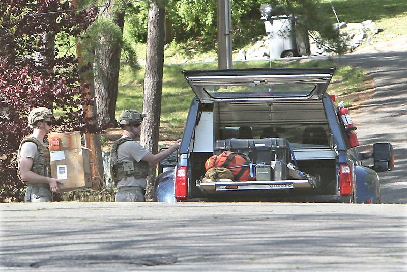 The Sentinel-Record/Richard Rasmussen BOMB SQUAD: Members of the Little Rock Air Force Base Explosive Ordnance Disposal Team load what is believed to be a Civil War-era land mine into their vehicle Thursday before taking it to the Garland County Landfill to be detonated. The device was found in Danville by Hot Springs resident, Matt Bell, who initially thought it was a cannonball.