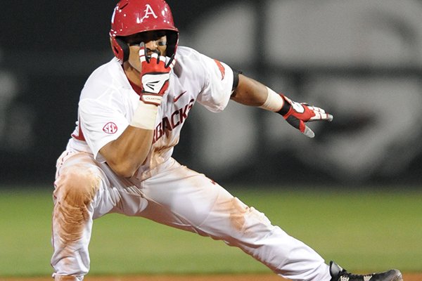 Arkansas shortstop Michael Bernal celebrates a tie-breaking hit at second base against Missouri Friday, April 1, 2016, during the sixth inning at Baum Stadium in Fayetteville.