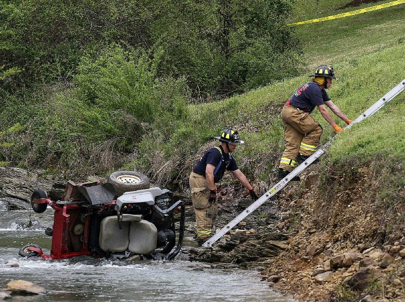 Arkansas Democrat-Gazette/BENJAMIN KRAIN --4/1/2016-- 
Little Rock fire fighters remove the body of a 33-year-old landscaper killed as the mower tipped over a steep embankment and into the creek below while working at Stonebridge Apartments in west Little Rock on Friday. It was not clear if the man drowned or was killed in the fall.