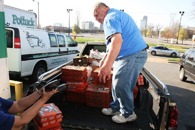 On a recent morning Maurice Douglas from Helping Hand of Greater Little Rock helped load pizza and other food at Potluck Inc.’s North Little Rock facility. “When we get low on meat, we’ll ask the client, ‘Do you want meat or pizza?’ They pick pizza,” says Gayle Priddy.