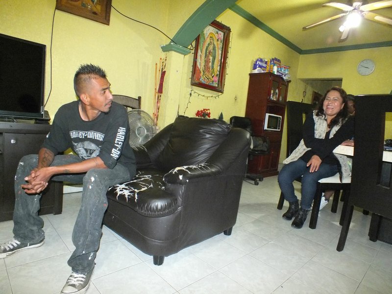 Jonathan Rodriguez (left) speaks with his aunt Enriqueta Razo in her home Dec. 19 in Irapuato, Guanajuato, Mexico. Razo will open up her home to the soon to be deported Erick Rodriguez, Jonathan's brother, after being detained for having used a fake Social Security card while he lived in Fayetteville.