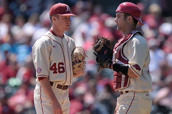 Arkansas pitcher Barrett Loseke (46) talks with catcher Tucker Pennell during a game against Missouri on Sunday, April 3, 2016, at Baum Stadium in Fayetteville. 