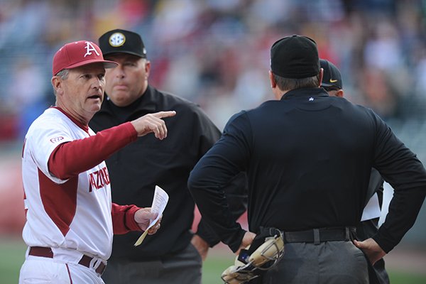 Arkansas coach Dave Van Horn explains the ground rules to the game officials and Missouri coaches Friday, April 1, 2016, before the start of play at Baum Stadium in Fayetteville.