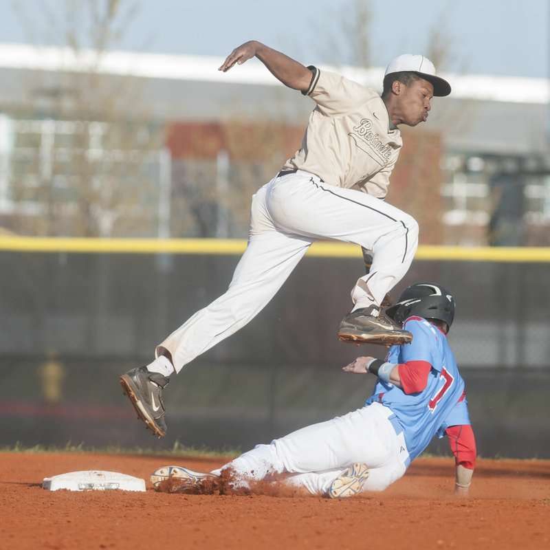 Bentonville’s Kam’ron Mays-Hunt tries to get a handle on the ball Monday as Fort Smith Southside’s Spencer Plunkett slides into second base. Bentonville lost 5-1.