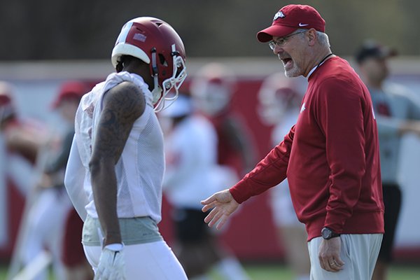 Arkansas assistant coach Paul Rhoads speaks with his players Thursday, March 31, 2016, during practice at the university's practice field on campus in Fayetteville.