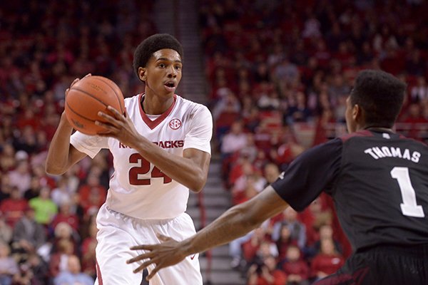 Arkansas' Jimmy Whitt looks to pass against Mississippi State's Fred Thomas during a game Saturday, Jan. 9, 2016, at Bud Walton Arena in Fayetteville. 