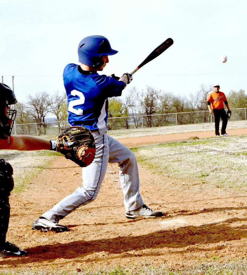 Photo by Mike Eckels Troy Flood (Decatur #2) hits a long fly ball to left field to bring two runners home during the March 29 Decatur Bulldog season opener against the Watts (Okla.) Engineers at Edmiston Park in Decatur. The Bulldogs took their first win, defeating Watts, 13 to 1.