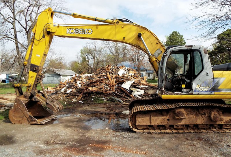 Photo by Randy Moll The old house on the corner of Collins and S. Second was reduced to a pile of rubble on Thursday morning, with the scraps being hauled away. The ca. 1930s home was owned by Don Evans and demolished because of its condition and the cost of repairing it.