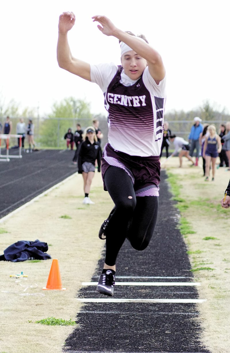 Photo by Randy Moll Jon Faulkenberry, of Gentry, clears some ground during the triple jump at the Gravette invitational track meet on Thursday in Lion Stadium.