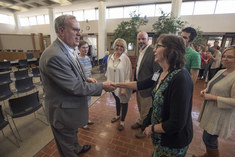 Jodi Mears (right), assistant principal at Kirksey Middle School in Rogers, meets Marlin Berry on Tuesday during a reception. Berry on Tuesday was offered the Rogers school superintendent job.