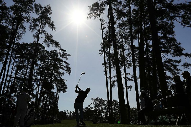 Former Arkansas Razorback David Lingmerth tees off on No. 17 at Augusta National Golf Club on Wednesday during a practice round for the Masters, which begins today. Lingmerth was one of nine golfers to make holes-in-one during Wednesday’s par-3 tournament.