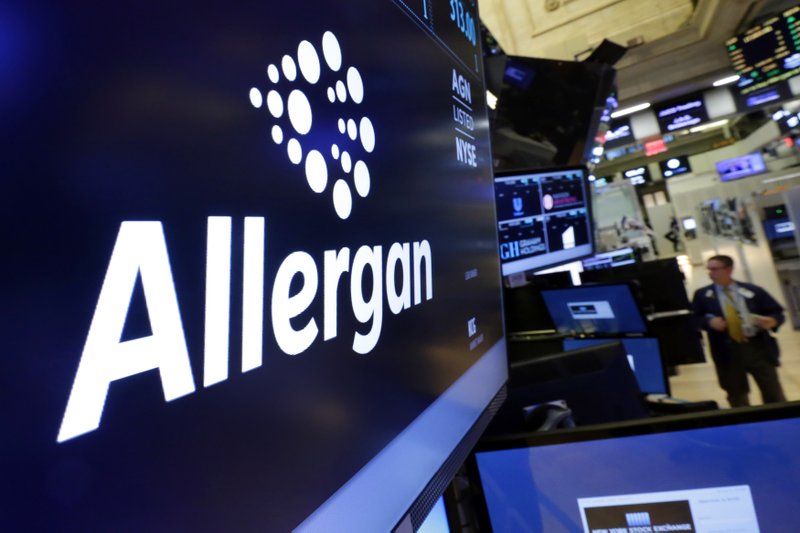 In this Nov. 23, 2015, file photo, the Allergan logo appears above a trading post on the floor of the New York Stock Exchange. 