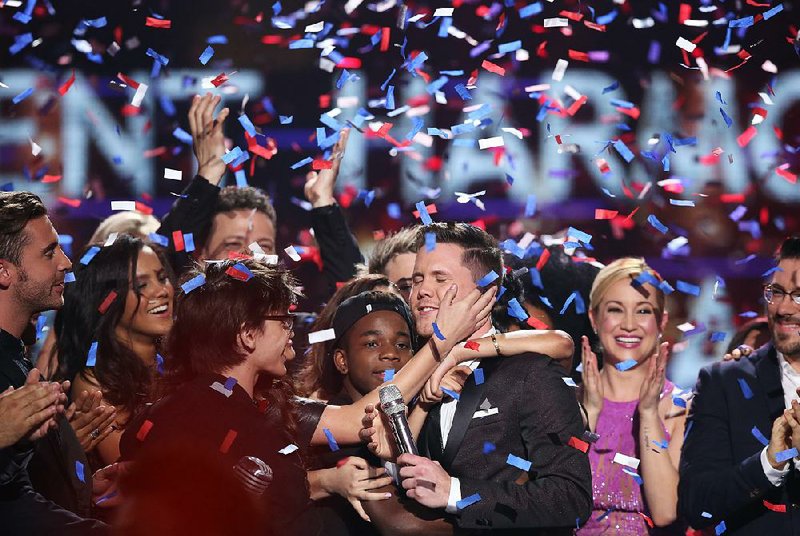 Trent Harmon (center), winner of American Idol The Farewell Season,celebrates with fellow contestants during the season finale at the Dolby Theatre on Thursday in Los Angeles.