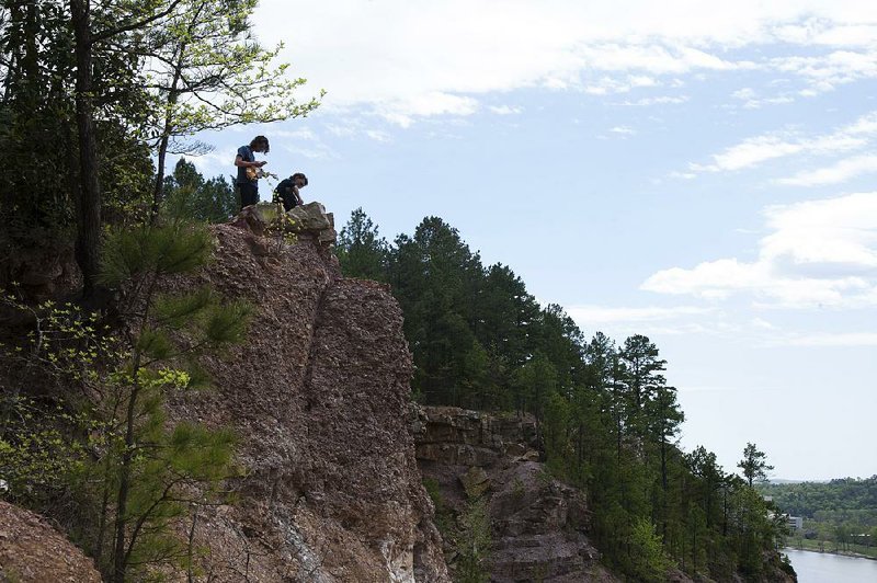 Arkansas Democrat-Gazette/MELISSA SUE GERRITS - 04/07/16 - Seth Gibbs, left, on a mandolin and brother Blake Gibbs on a 12 string guitar, play together in Emerald Park overlooking the rock quarry in North Little Rock April 7, 2016. "I just believe I have to give people music", said Seth, as he hopes to graduate from Pulaski Tech and then play music full time. 