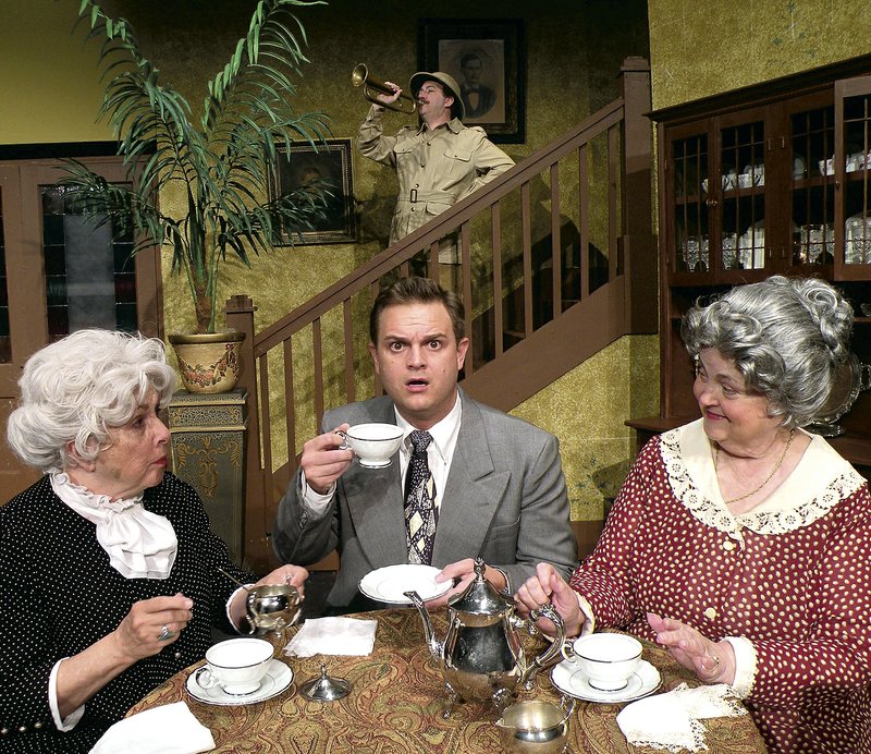 Sisters Martha (Pat Smith, left) and Abby (Judy Scott, right) explain their deadly hobby to their nephew Mortimer (Doug Robinson, center) while their brother Teddy (David Godwin) looks on from San Juan Hill in the Arts Center of the Ozarks production of the classic comedy “Arsenic and Old Lace.”