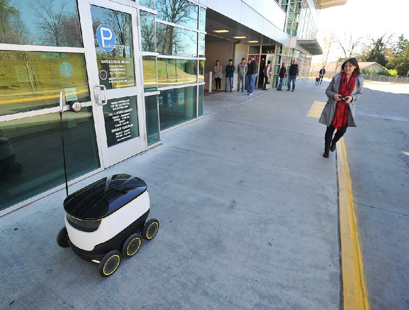 Helen Kaarlep, head of testing and operations at Starship Technologies, operates a delivery robot at the University of Arkansas at Fayetteville. 