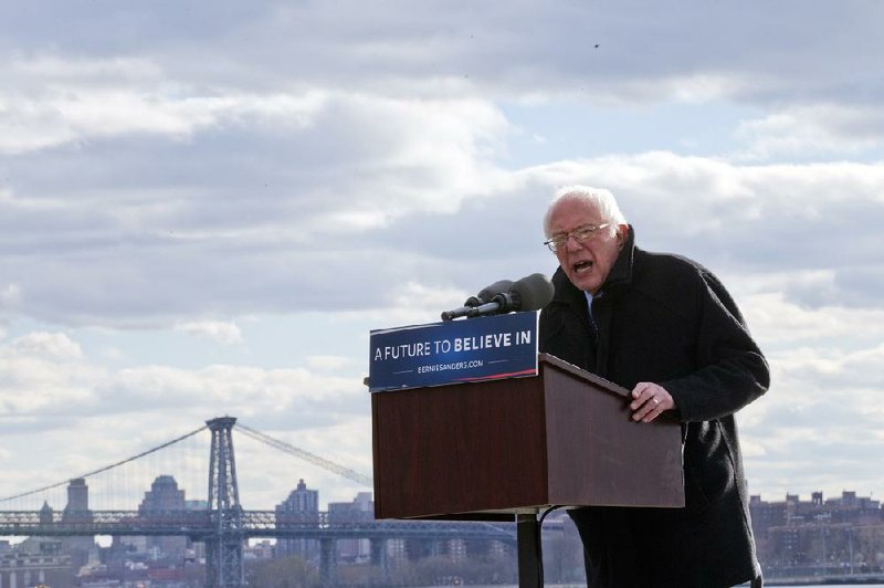 Bernie Sanders speaks at a rally Friday in Brooklyn. Sanders softened his criticism of Hillary Clinton but said he would not be “a doormat” by not responding forcefully if attacked. 
