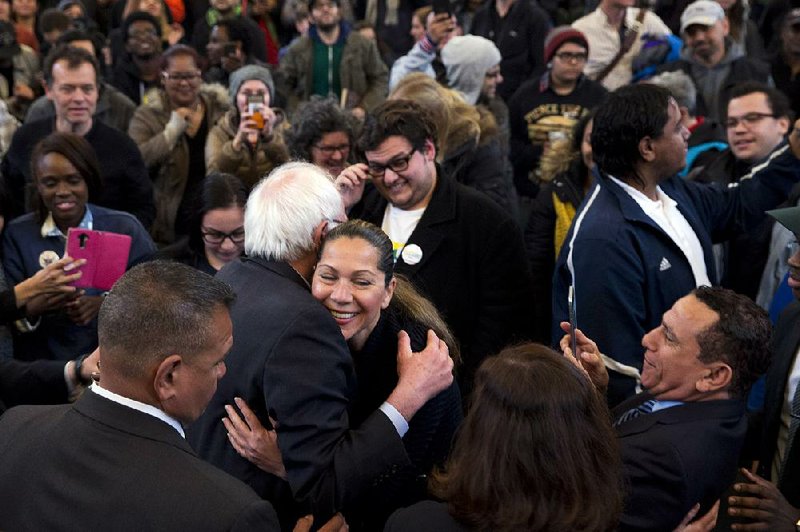 Democratic presidential candidate Bernie Sanders hugs a supporter Saturday at a rally in the Bronx borough
of New York. Sanders’ victory Saturday in Wyoming was his seventh in the past eight state contests.