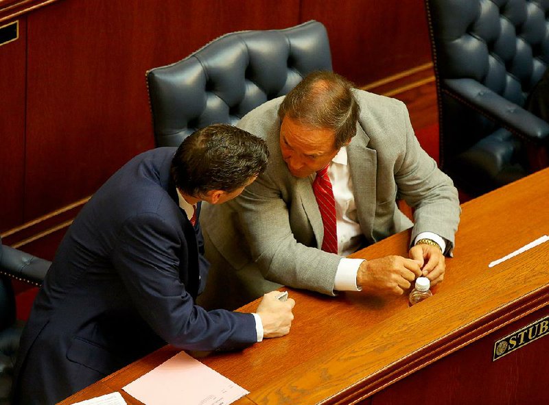 Sen. Scott Flippo (left) confers Friday on the Senate floor with Sen. Gary Stubblefield. Both voted against the expanded Medicaid plan and say they’ll oppose funding for the program.