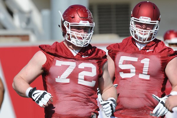 Arkansas offensive linemen Frank Ragnow and Hjalte Froholdt take part in a drill Tuesday, March 29, 2016, during practice at the university's practice field on campus in Fayetteville.