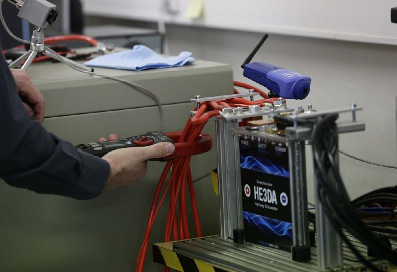 A worker tests a battery at the Prague-based HE3DA company in the Czech Republic last month.
