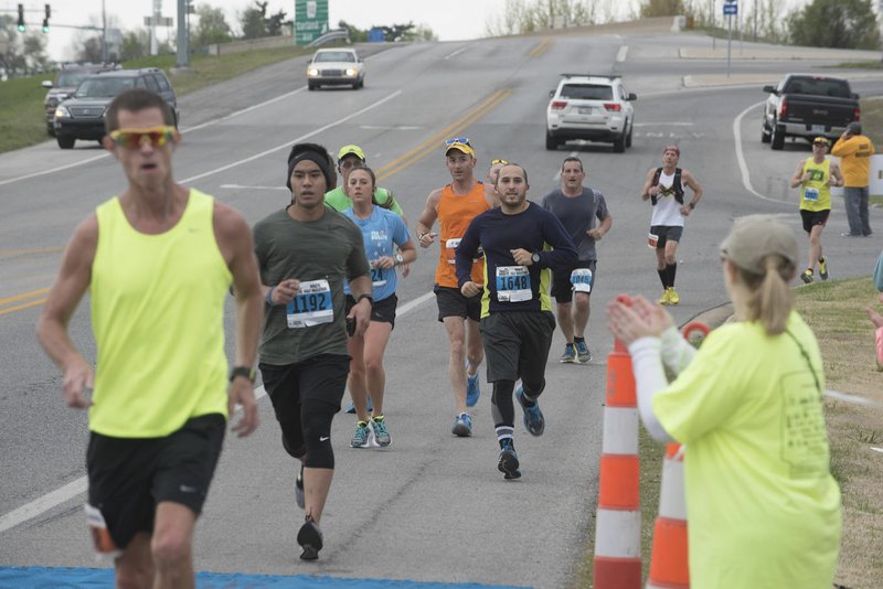 Runners make their way Sunday along Arkansas 112 during the 40th Hogeye Marathon &amp; Relays.