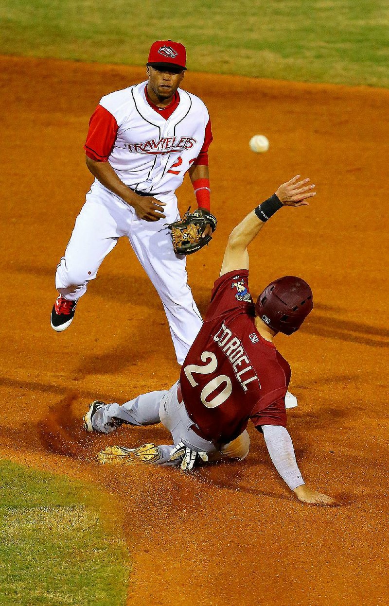 Arkansas second baseman Sherman Johnson (left) tries to turn a double play as Frisco base runner Ryan Cordell slides toward the bag during the sixth inning of Monday’s game at Dickey-Stephens Park in North Little Rock. The Travelers were held to one hit in losing 1-0 in front of 2,096.