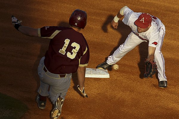 Arkansas infielder Cody Scroggins tags Louisiana-Monroe base runner Jacob Stockton during a game Tuesday, April 12, 2016, at Dickey-Stephens Park in North Little Rock. 