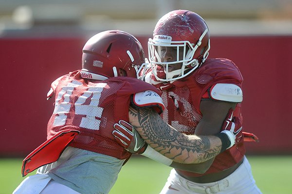 Arkansas tight ends Jeremy Sprinkle (83) and Austin Cantrell (44) go through drills during practice Thursday, April 7, 2016, in Fayetteville. 