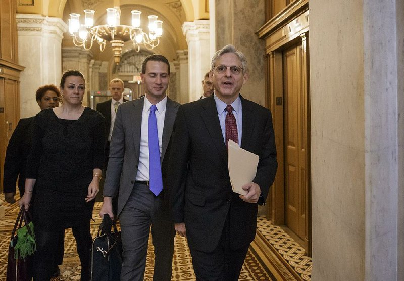 Appeals Judge Merrick Garland (right) heads to a breakfast meeting Tuesday where Senate Judiciary Committee Chairman Charles Grassley told Garland that his Supreme Court nomination will not get a hearing. 