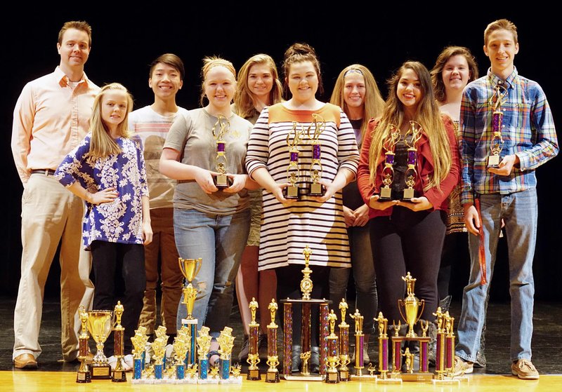 Photo by Randy Moll Gentry&#8217;s forensics team has had a winning year. The team, pictured with trophies and awards won, includes Coach Daren Ward (left), freshman Nicole Guntharp, junior Michael Lee, junior Alex Savage, sophomore Ashlyn Riggs, senior Emiley Dilbeck, senior Lexie Clark, junior Rebecca Brown, junior Audra Weathers, junior Colton Little and senior James Fell (not pictured).