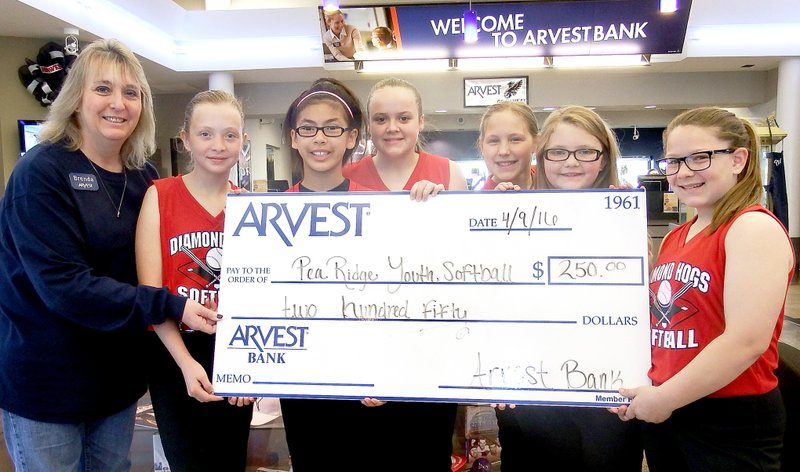 TIMES photograph by Annette Beard Members of the girls&#8217; Diamond Hogs softball 12U team Ashly Williams, Allie King, Sadie Prince, Dallice White, Remi Perez, Nalea Holliday accepted a $250 check from Brenda Flanagan of Arvest, Pea Ridge, Saturday. The girls are coached by Mary King.