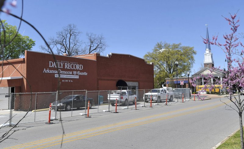 Construction crews begin renovation on the former Benton County Daily Record building Tuesday in Bentonville. The building is to be renovated into an event center.