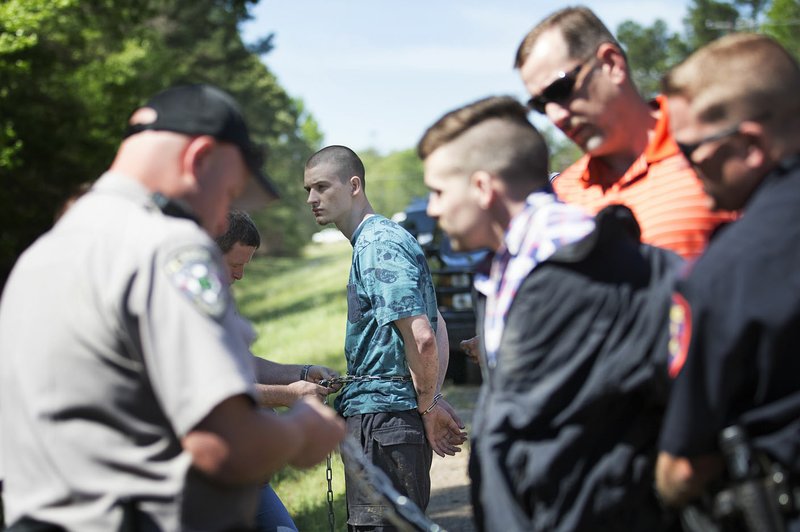 Matthew Miller, 22, (left) of Eagle Rock, Mo., and Keith Davis, 24, of Anderson, Mo., wait Tuesday to be taken to the Bi-State Justice Building in Texarkana after Bowie County, Texas, sheriff’s deputies captured the two escaped inmates. The men were found on the TexAmerica’s property, an industrial park about 25 miles west of Texarkana, Texas. The inmates escaped the McDonald County jail in Pineville, Mo., on Sunday.