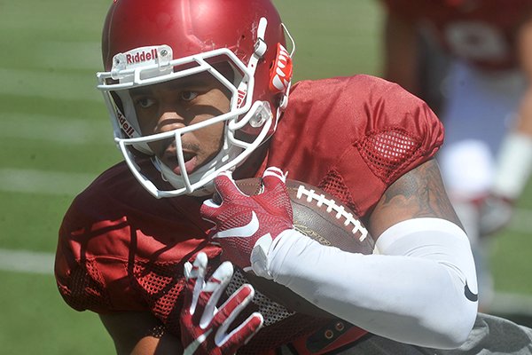 Jared Cornelius goes through drills during practice Saturday, April 9, 2016, at Razorback Stadium in Fayetteville. 