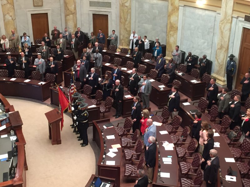 A color guard presents the American and Arkansas flags during the opening of the state House of Representatives for the legislature's fiscal session Wednesday. 