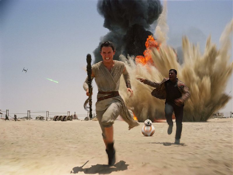 This photo provided by Disney shows Daisey Ridley as Rey, left, and John Boyega as Finn, in a scene from the new film, "Star Wars: Episode VII - The Force Awakens," directed by J.J. Abrams. The movie, which received a PG-13 rating, releases in the U.S. on Dec. 18, 2015. (Film Frame/Disney/Copyright Lucasfilm 2015 via AP