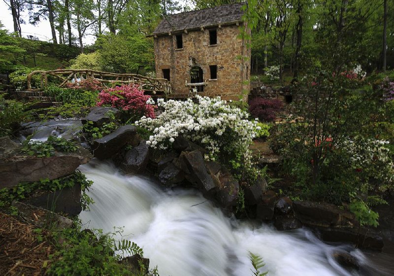 Arkansas Democrat-Gazette/STATON BREIDENTHAL --4/13/16-- Water rushes down a waterfall Wednesday afternoon following a rain shower at the Old Mill in North Little Rock.